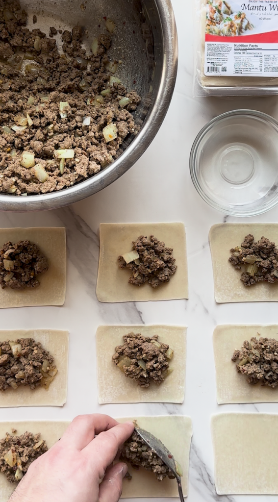 mantu being prepped with dumpling wraps from Ariana sweets